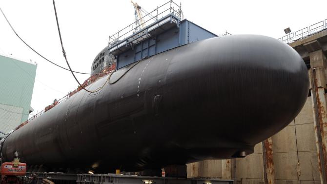 In this Thursday, July 30, 2015 photo, shipyard workers at General Dynamics Electric Boat prepare the submarine Illinois for float-off in Groton, Conn.  The U.S. Navy is using a new painting process and dozens of other innovations aimed at reducing the maintenance needs for attack submarines, which are coming out of service faster than they can be replaced. (AP Photo/Jessica Hill)