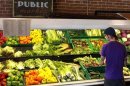 A customer looks over produce at the Phoenix Public Market in Phoenix