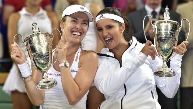Switzerland&#39;s Martina Hingis (L) and India&#39;s Sania Mirza pose with the winner&#39;s trophies during the presentation after winning the women&#39;s doubles final on day twelve of the 2015 Wimbledon Championships in southwest London, on July 11, 2015