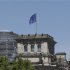 EU and German national flag are set up atop Reichstag building in Berlin