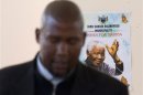 Mandela, grandson of former South African President Mandela, sings in front of a poster of his grandfather during a church service near the home of the former president in Qunu