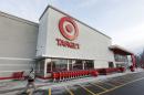FILE - In this Dec. 19, 2013, file photo, a passer-by walks near an entrance to a Target retail store in Watertown, Mass. Target Corp. reports quarterly financial results before the market opens on Wednesday, Feb. 26, 2014. (AP Photo/Steven Senne, File)