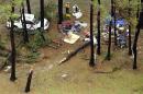 In this aerial photo people inspect damage at Cherrystone Family Camping & RV Resort in Northampton County, Thursday, July 24, 2014, near Cheriton, Va., after a severe storm swept through the area. Softball-sized hail and rain toppled dozens of trees and flipped recreational vehicles at the campground Thursday, killing two people and injuring more than two dozen, officials said. (AP Photo/The Virginian-Pilot, L. Todd Spencer) MAGS OUT
