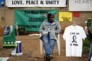 A street vendor sells t-shirts and fabric outside the hospital where ailing former President Nelson Mandela is being treated in Pretoria