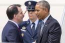 Wisconsin Gov. Scott Walker greets President Barack Obama as he arrives on Air Force One, Thursday, July 2, 2015, at La Crosse regional airport in La Crosse, Wis. Nudging his way into presidential politics, President Barack Obama traveled to Wisconsin on Thursday to draw contrasts with Republicans on economic policy just as the state's governor, Scott Walker, was filing paperwork to enter the GOP presidential primary. (AP Photo/Tom Lynn)