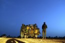 Malian soldiers patrol on a road between Kidal and Gao on July 29, 2013 in northern Mali