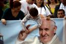 Citizens wait for the arrival of Pope Francis at Mother Teresa square in central Tirana on September 21, 2014