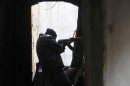 A member of the Free Syrian Army aims his gun during clashes with forces loyal to Syria's President Assad, in Aleppo