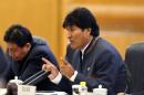 Bolivian President Evo Morales (R) talks as he meets with Chinese President Xi Jinping (not in picture) at the Great Hall of the People in Beijing on December 19, 2013