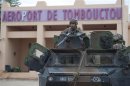 French troops, aboard an armoured vehicle, guard the Timbuktu airport