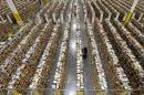 An Amazon.com employee stocks products along one of the many miles of aisles at an Amazon.com Fulfillment Center on "Cyber Monday" the busiest online shopping day of the holiday season Monday, Dec. 2, 2013, in Phoenix. Over 2,000 employees will work the over 1-million square foot facility on "Cyber Monday." (AP Photo/Ross D. Franklin)