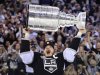 Los Angeles Kings right wing Dustin Brown (23) holds up the Stanley Cup after the Kings beat the New Jersey Devils 6-1 during Game 6 of the NHL hockey Stanley Cup finals, Monday, June 11, 2012, in Los Angeles. (AP Photo/Mark J. Terrill)