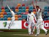 Sri Lanka's Dilshan watches as Australia's Watson and Wade celebrate his dismissal during the fourth day's play in their first cricket test match in Hobart