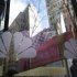 NBC logos are seen on a door with buildings around Rockefeller Center reflected in the background at the home of NBC's studios, in New York,