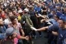 Migrants face Hungarian police in the main Eastern Railway station in Budapest