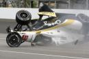 The car driven by Josef Newgarden slides down the track after hitting the wall in the first turn and going airborne during practice for the Indianapolis 500 auto race at Indianapolis Motor Speedway in Indianapolis, Thursday, May 14, 2015. (AP Photo/Joe Watts)