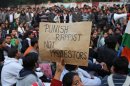 A demonstrator holds a placard during a protest in New Delhi