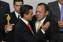 Jesus Zambrano hugs Mexico's President Enrique Pena Nieto during the presentation of a telecommunications reform bill in Mexico