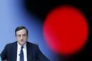 President of European Central Bank Mario Draghi speaks during a news conference in Frankfurt, Germany, Thursday, Dec.4, 2014, following a meeting of the ECB governing council. Draghi will assess the state of the economy at the news conference after the bank decided to leave its main interest rate at 0.05 percent. The red light is from a TV camera. (AP Photo/Michael Probst)