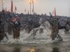 Indian Hindu holy men, or Naga Sadhus, run naked into the water at Sangam, the confluence of the Ganges, Yamuna and mythical Saraswati river, during the royal bath on Makar Sankranti at the start of the Maha Kumbh Mela in Allahabad, India, Monday, Jan. 14, 2013. Millions of Hindu pilgrims are expected to take part in the large religious congregation that lasts more than 50 days on the banks of Sangam which falls every 12 years. (AP Photo/Kevin Frayer)