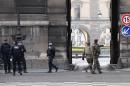 French police officers and soldiers patrol in front of the Louvre museum in Paris on February 3, 2017 after a soldier shot and gravely injured a man who tried to attack him