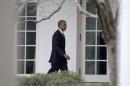 President Barack Obama walks along the colonnade of the White House in Washington, Tuesday, Jan. 12, 2016, to the residence from the Oval Office hours before giving his State Of The Union address. (AP Photo/Carolyn Kaster)