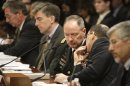 NSA Director Alexander confers with FBI Deputy Director Joyce as they testify at the U.S. Capitol in Washington