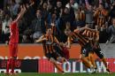 Hull City's defender Michael Dawson (2R) celebrates scoring the opening goal during the English Premier League football match against Liverpool in Hull on April 28, 2015