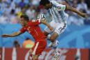 Switzerland's Xherdan Shaqiri, left, and Argentina's Ezequiel Garay go for a header during their World Cup round of 16 soccer match at the Itaquerao Stadium in Sao Paulo, Brazil, Tuesday, July 1, 2014. (AP Photo/Kirsty Wigglesworth)