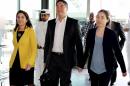 American couple Grace, right, and Matthew Huang walk to their departure gate with U.S. Ambassador to Qatar, Dana Shell Smith, left, at the Hamad International Airport in Doha, Qatar, Sunday, Nov. 30, 2014. A Qatari appeals court on Sunday overturned a ruling against an American couple over the death of their adopted daughter and said they are free to leave, ending a closely watched legal saga that may have stemmed from cultural misunderstandings in the conservative Gulf nation. (AP Photo/Osama Faisal)