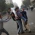 An injured protester is aided by others during clashes with Egyptian security forces, not pictured, near Tahrir Square in Cairo, Egypt, Saturday, Nov. 26, 2011. Egyptian medical officials say that one demonstrator has been killed outside the country's Cabinet building, where protesters have camped overnight to prevent the entrance of the country's newly-appointed prime minister. (AP Photo/Bernat Armangue)