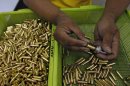A gun factory worker fits a bullet on a chamber of a revolver at Shooters Arms, a gun manufacturing company exporting different kinds of weapons to other countries, in Cebu city
