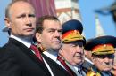 Russian President Vladimir Putin, left, and Prime Minister Dmitry Medvedev attend a Victory Day parade, which commemorates the 1945 defeat of Nazi Germany, at Red Square in Moscow, Russia, Friday, May 9, 2014. Russia marked the Victory Day on May 9 holding a military parade at Red Square. (AP Photo/RIA-Novosti, Mikhail Klimentyev, Presidential Press Service)
