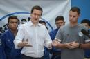 British Finance Minister George Osborne (L) speaks during his visit to the Fight for Peace NGO, run by his schoolmate in England Luke Dowdney (R) at the Favela da Mare shantytown in Rio de Janeiro, Brazil, on April 7, 2014