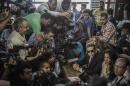 Al-Jazeera journalists Mohamed Fahmy (bottom, 3rd from R) and Baher Mohamed (center, 2nd from R), talk to the press during their trial in Cairo on August 29, 2015