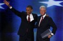 U.S. President Obama joins former President Clinton onstage after Clinton nominated Obama for re-election during the second session of the Democratic National Convention in Charlotte