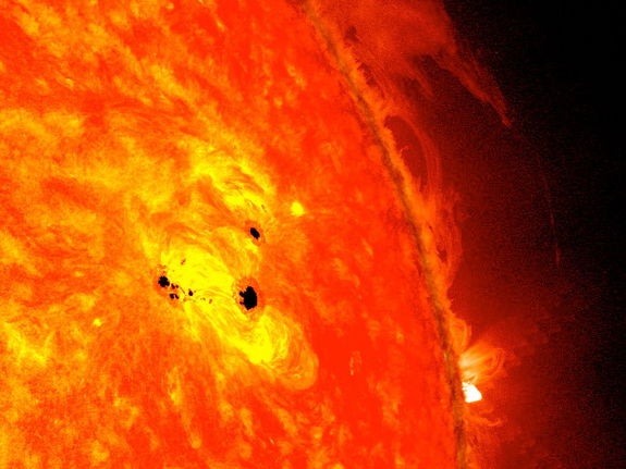The bottom two black spots on the sun, known as sunspots, appeared quickly over the course of Feb. 19-20, 2013. These two sunspots are part of the same system and are over six Earths across.
