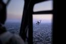 A picture taken on board a helicopter shows an US State Department helicopter flying over the Iraqi capital Baghdad as it transports US Secretary of State John Kerry on June 23, 2014