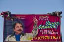 FILE - In this Dec. 21, 2015 file photo, workers install a billboard supporting Nicaragua's President Daniel Ortega along a street Managua, Nicaragua. The banner's message reads in Spanish: "Let's move ahead! In good hope, in victories!" The Supreme Electoral Council unseated 16 opposition legislators from the Liberal Independent Party and its ally the Sandinista Renovation Movement Friday, July 29, 2016, for not recognizing their leader. That leader, Pedro Reyes, had recently been given that authority by the Supreme Court, which removed the party's previous leader following a long-running political dispute. Reyes is seen by some within his own party as a tool of Ortega. (AP Photo/Esteban Felix, File)