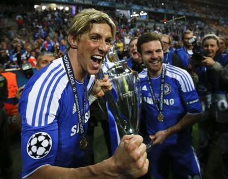 Torres and Mata of Chelsea celebrate with the UEFA Champions League trophy after their final soccer match against Bayern Munich at the Allianz Arena in Munich