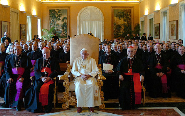 FILE - This Sept. 15, 2006 file photo released by the Vatican's newspaper L'Osservatore Romano shows Pope Benedict XVI, at center, presiding a meeting with outgoing Vatican Secretary of State Cardinal Angelo Sodano, left foreground in red, and the new Vatican's No. 2 official Cardinal Tarcisio Bertone, right foreground in red, during a meeting at the Vatican. After 35 years under two "scholar'' popes who paid scant attention to the internal governance of the Catholic Church, a chorus is growing that the next pontiff must have a solid track record managing a complicated bureaucracy. Benedict was well aware of the problems, having spent nearly a quarter-century in the Vatican's Congregation for the Doctrine of the Faith. But he never entered into the Vatican's political fray as a cardinal _ and as pope left it to his No. 2, Cardinal Tarcisio Bertone, to do the job. (AP Photo/L'Osservatore Romano, ho, files)