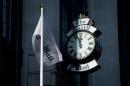 The Daily Mail flag and clock are shown above outside the headquarters of UK newspaper The Daily Mail in London, England, on October 6, 2013