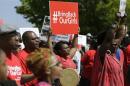 Protesters march in support of the girls kidnapped by members of Boko Haram in front of the Nigerian Embassy in Washington