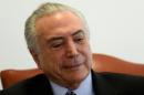 Brazilian acting President Michel Temer talks with journalists of international press agencies at Planalto Palace in Brasilia on July 29, 2016