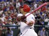 Texas Rangers' Nelson Cruz follows through on a grand slam off a pitch from Los Angeles Angels' Jered Weaver in the third inning of a baseball game, Sunday, May 13, 2012, in Arlington, Texas. The shot scored David Murphy, Adrian Beltre and Michael Young. (AP Photo/Tony Gutierrez)