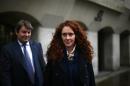 Former News International chief executive Rebekah Brooks leaves the Old Bailey courthouse with her husband Charlie in London