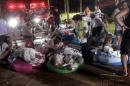 Injured victims from an accidental explosion during a music concert lie on the ground at the Formosa Water Park in New Taipei City