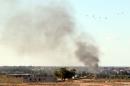 Smoke billows from buildings after the air force from the pro-government forces loyal to Libya's Government of National Unity fired rockets targeting Islamic State (IS) group positions in Sirte on July 18, 2016
