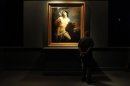 A visitor admires a painting by 17th century master Guido Reni at the Vatican