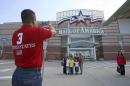 Family poses for a souvenir photograph in front of an entrance to the Mall of America